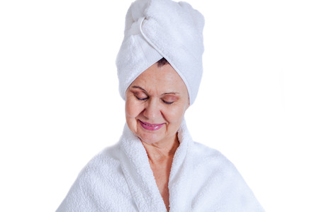 Spa concept portrait. Aged good looking woman with white towel on her headの写真素材