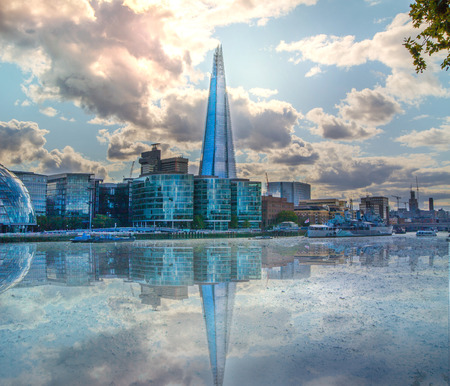 LONDON, UK - AUGUST 16, 2014: Shard of glass on river Thames. Modern London architectureのeditorial素材