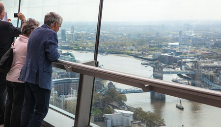 LONDON UK  APRIL 22 2015: People looking at the London's skyline. Viewing platform of WalkieTalkie building. Locates on 32 floor and offering amazing view of the city.のeditorial素材