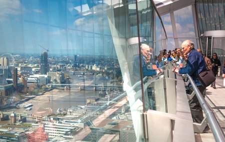 LONDON UK  APRIL 22 2015: People looking at the London's skyline. Viewing platform of WalkieTalkie building. Locates on 32 floor and offering amazing view of the city.のeditorial素材