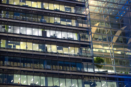 LONDON, UK - 7 SEPTEMBER, 2015: Canary Wharf office's windows lit up in the night.のeditorial素材