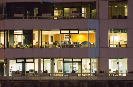 LONDON, UK - 7 SEPTEMBER, 2015: Canary Wharf office's windows lit up in the night.のeditorial素材