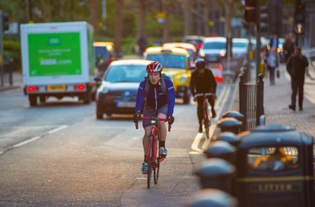 LONDON, UK - 7 SEPTEMBER, 2015: Londoners commuting from work by bike. Road view with cars and bikersのeditorial素材