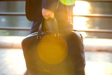 Business man in suit walking against of sunset light, Londonの写真素材