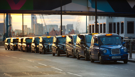 LONDON, UK - 7 SEPTEMBER, 2015:  Taxis at sunset light waiting for the call. Canary Wharf evening lifeのeditorial素材