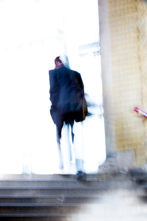 Businessmenwalking up to stairs, blur background. Londonの写真素材