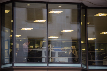 LONDON, UK - SEPTEMBER 19, 2015: Business people having a meeting. View trough the windowのeditorial素材