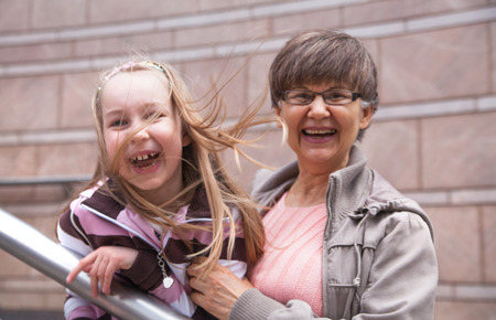 Senior lady with granddaughter outdoor portrait in the cityの写真素材