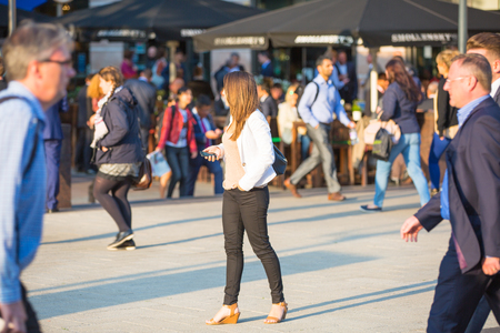 LONDON, UK - SEPTEMBER 9, 2015: Office workers going home after working day in Canary Wharf. Business life of Londonのeditorial素材