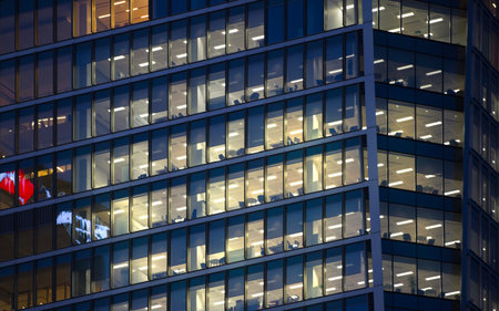 LONDON, UK - 7 SEPTEMBER, 2015: Canary Wharf office's windows lit up at dusk, Business life concept...