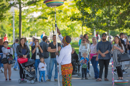 LONDON, UK - SEPTEMBER 10, 2015: Street performance by African's artists at south embankment of the River Thames. Lots of people watching the show at the backgroundのeditorial素材
