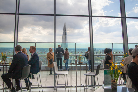 LONDON, UK - APRIL 22, 2015: People in sky cafe resting and enjoying the London panorama from 32 floor of Walkie-Talkie buildingのeditorial素材