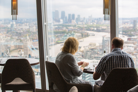 LONDON, UK - SEPTEMBER 17, 2015: People in restaurant at the 34 floor enjoying the meal and London view. London panoramaのeditorial素材