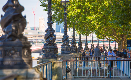 LONDON, UK - SEPTEMBER 10, 2015: Embankment of River Thames and walking peopleのeditorial素材