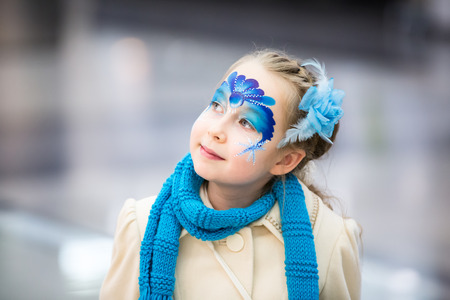 Portrait of little girl with Christmas face paintingの写真素材