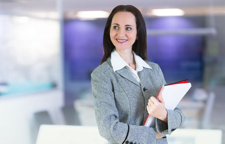 Attractive woman portrait with notepad in the office