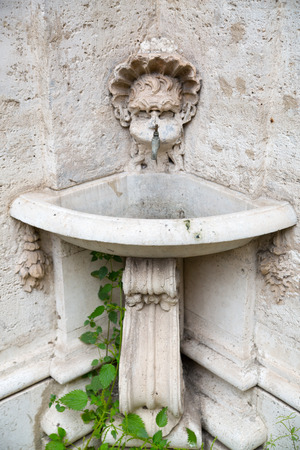 Fountain in the inner yard of Italian buildingの写真素材