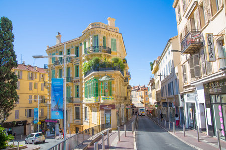 CANNES, FRANCE - 19 SEPTEMBER, 2016: Centre of the town view with restaurants, cafes and lots of walking people. Old city of Cannes colorful houses.のeditorial素材