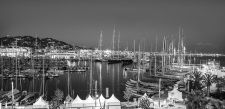 CANNES, FRANCE - 19 SEPTEMBER, 2016:   Old Port Vieux Port in the city of Cannes at night. Lots of sailing boats and power yachts anchored during the Sailing regatta.のeditorial素材