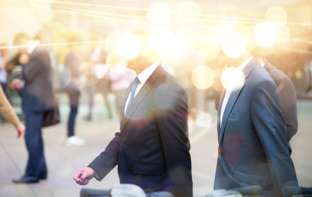 Business people walking in the City, blurred image with lights reflection. Business and modern life conceptの写真素材