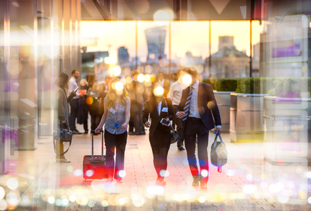 Business people walking in the City, blurred image with lights reflection. Business and modern life conceptの写真素材