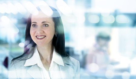 Successful business woman portrait in office against of glass reflectionの写真素材