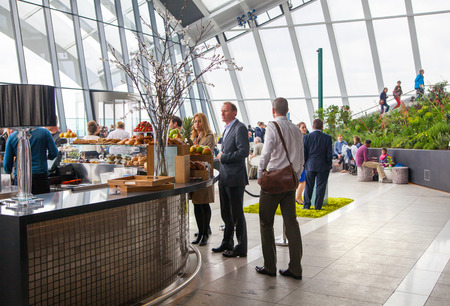 LONDON, UK - APRIL 22, 2015: People in the restaurant of the Sky Garden Walkie-Talkie building. Viewing platform is heist UK garden, locates at the 32 floor and offers amazing skyline of London city.のeditorial素材