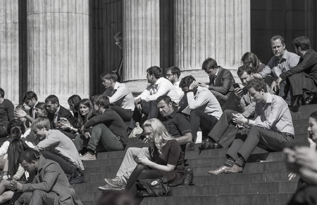 LONDON, UK - JUNE 30, 2014: Office workers al lunch time in the square of St. Paul's cathedral. City of London business lifeのeditorial素材