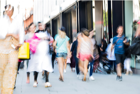 Blurred image of walking people. Londoners and tourists walking in Oxford street, one of the main shopping destination of Londonの写真素材
