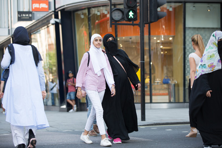 LONDON, UK -  August 24, 2016: Arabic woman walking in Oxford street, one of the main shopping destination of Londonのeditorial素材