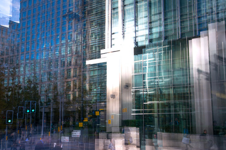 Multiple exposure effect image. Canary wharf office buildings view from the dock.の写真素材
