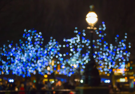 South bank of the river Tames at night with Christmas lights and walking people. Blurred image for backgroundの写真素材