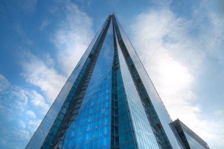 LONDON, UK - 17 May, 2016: Shard of Glass the tallest London skyscraper. Sky reflection at modern...