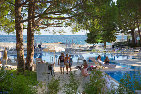 Monaco, Monte Carlo - September 15, 2016: Inner garden of the Le Meridien Beach Plaza hotel view with people enjoying holidays. Monaco, Monte Carlo - September 15, 2016: Le Meridien Beach Plaza hotel view with palms against of blue skyのeditorial素材