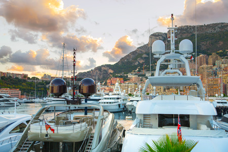 Monaco, Monte Carlo - September 16, 2016: Sunset in Principality of Monaco. View of the seaport and the city of Monte Carlo with luxury yachts and sail boatsのeditorial素材