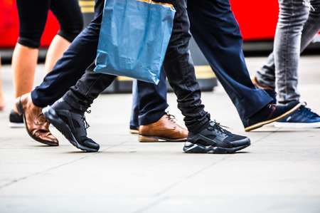 Feet of pedestrians walking on the crosswalk in Oxford street, London. Modern life, travel and shopping conceptの写真素材