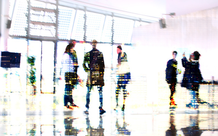 Silhouettes of business people walking in entrance hall. Multiple exposure blurred image. Business concept illustration.の写真素材