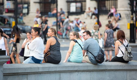 London, UK - 24 August, 2016: Trafalgar square with lots of people sitting on the stairs. Blurred imageのeditorial素材