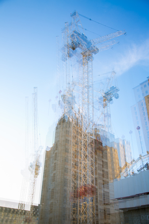 London, UK - November 30, 2016: Multiple exposure image of building construction site in the centre of London. Cranes and concrete contraction against of blue sky.のeditorial素材