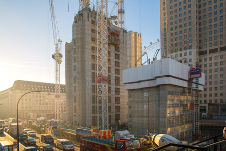 London, UK - November 30, 2016:  Building construction site in the centre of London. Crane, concrete contraction and London eye against of blue sky.のeditorial素材