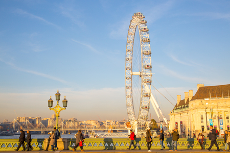 London, UK - November 30, 2016:  London Eye and people crossing the Westminster bridgeのeditorial素材