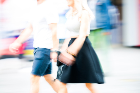 Young woman walking, blurred image. Londoners at warm summer day. UKの写真素材