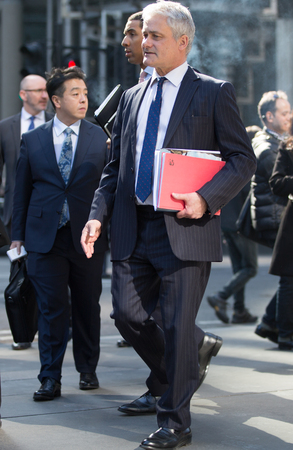 London, UK - March 15, 2017: Group of business people on the escalator in the City of London. Modern business life concept.のeditorial素材
