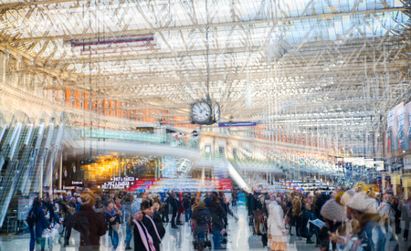 London, UK - November 30, 2016:  Multiple exposure image of lots of people walking and waiting for boarding in the Waterloo train station. Commuting rush hours concept, modern life.のeditorial素材