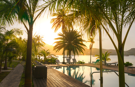 Antigua, Caribbean islands, English Harbour - May 20, 2017:  Swimming pool and English harbour view at the background in sunsetのeditorial素材