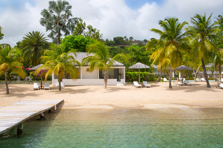 Antigua, Caribbean islands, English Harbour - May 20, 2017:  Galleon beach with beds and palmsのeditorial素材