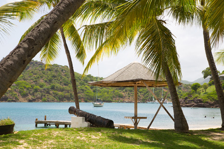 Antigua, Caribbean islands, English Harbour - May 20, 2017:  Galleon beach with beds and palmsのeditorial素材