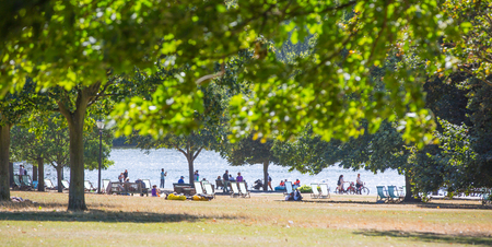 London, UK - September 8, 2016: Hyde Park  Serpentine man made lake and lots of people walking and resting in the parkのeditorial素材