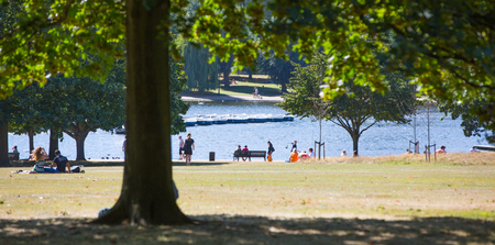 London, UK - September 8, 2016:  Lots of people spending afternoon in the Serpentine cafe next to lakeのeditorial素材