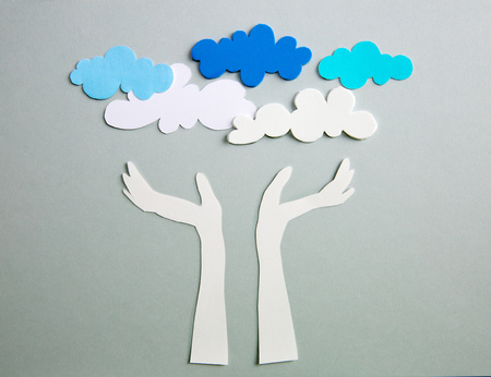 Human's hands raised up to the sky. Paper cut design.の写真素材